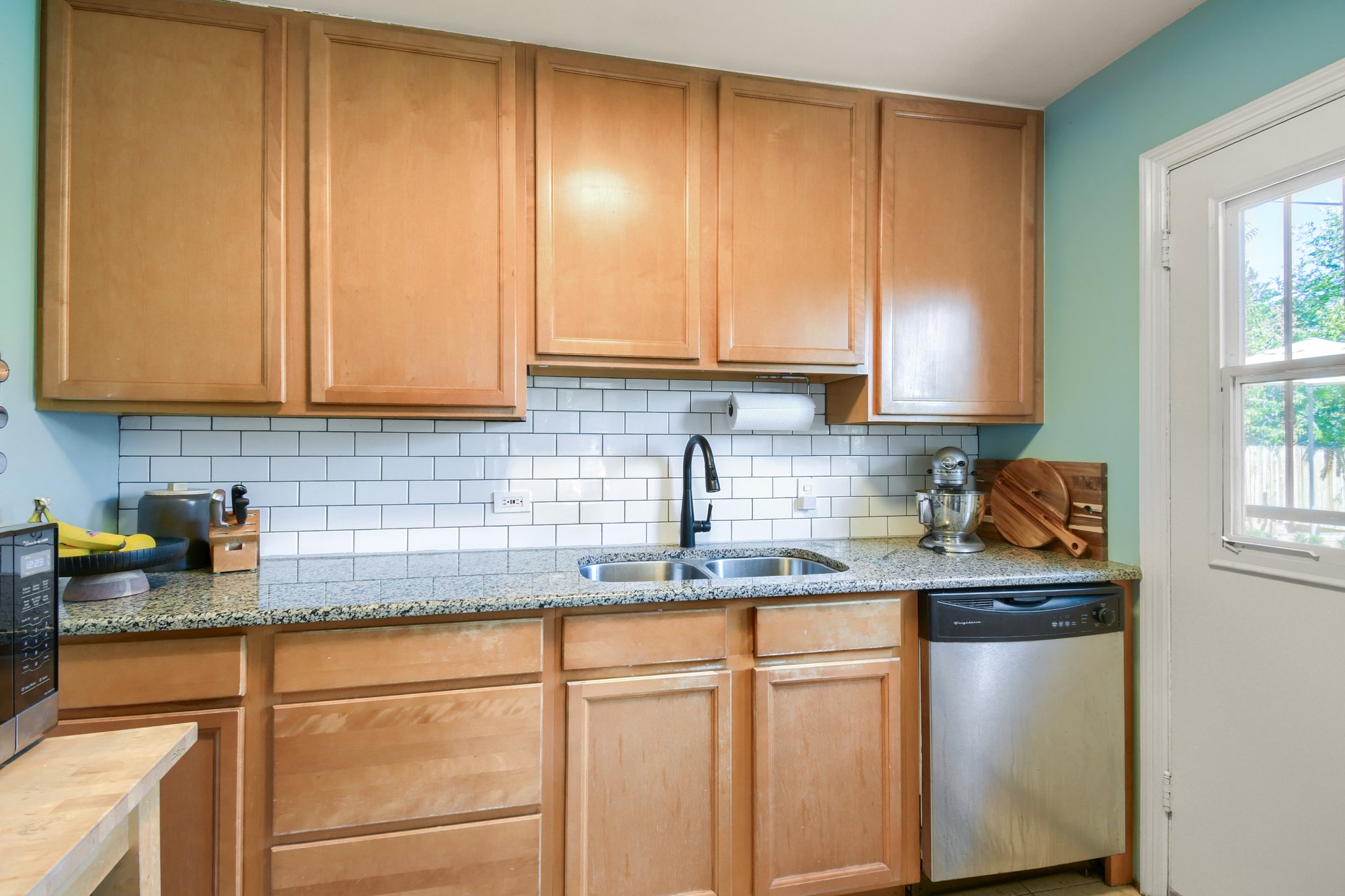 Kitchen with granite counters and subway tile