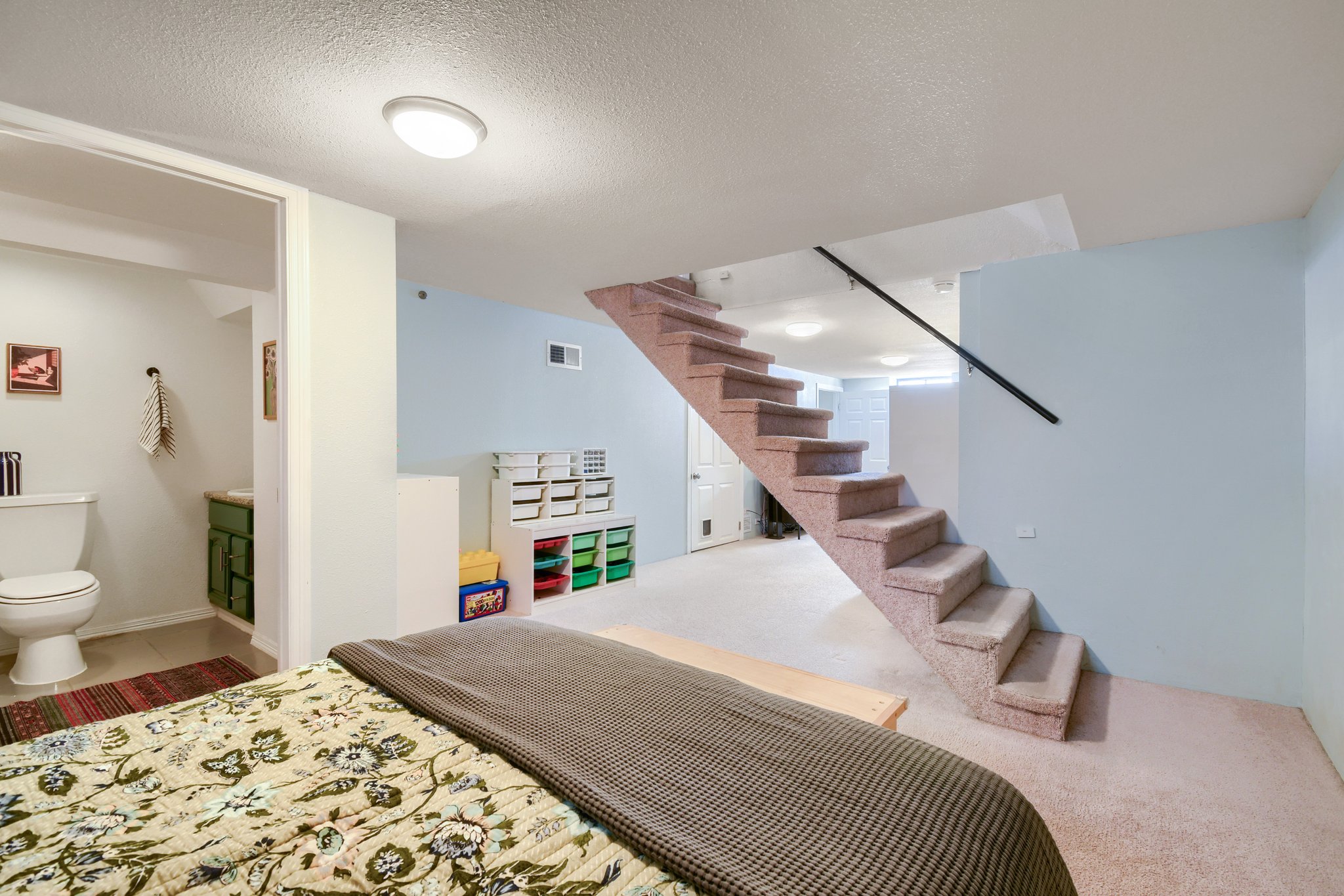 Recreation room with stairs and three-quarter bath